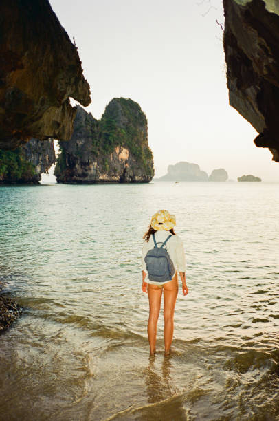 istock Woman walking on Railey beach and looking at stunning scenery 1475455161