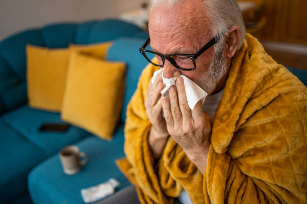 istock An elderly man sneezes, has a cold or flu, or is allergic to pollen. 1475456416
