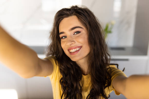 istock Cheerful young woman taking a selfie at the kitchen 1475458226