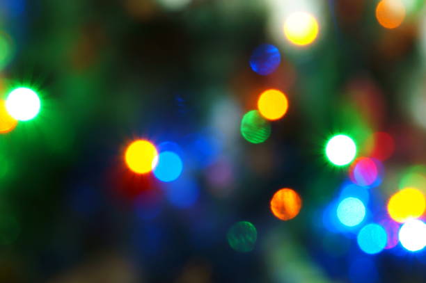 istock Blurred background. Glowing multicolored garland on the Christmas tree. 1475459495