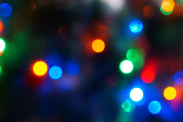 istock Blurred background. Glowing multicolored garland on the Christmas tree. 1475459496