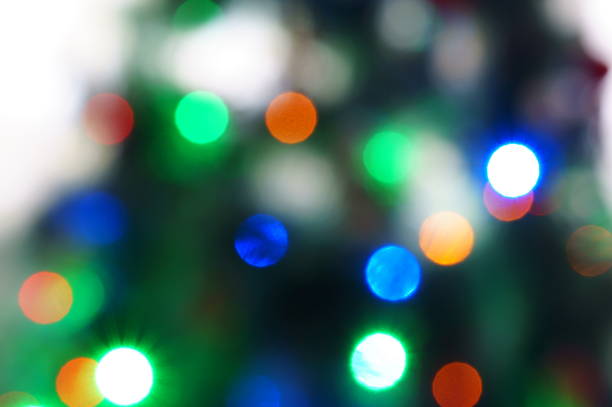 istock Blurred background. Glowing multicolored garland on the Christmas tree. 1475459497