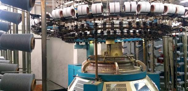 istock Circular knitting machine in Production floor, creel decorated by yarn. Knitting machine ready to production fabric in textile floor. Close view of industrial knitting machine. 1475461151
