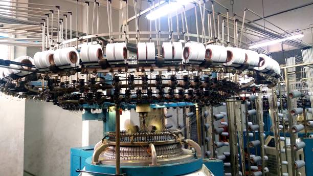 istock Circular knitting machine in Production floor, creel decorated by yarn. Knitting machine ready to production fabric in textile floor. Close view of industrial knitting machine. 1475461154