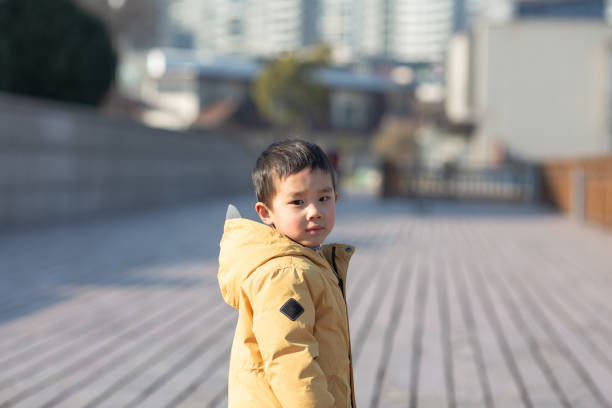 Little Asian boy playing outside. stock photo