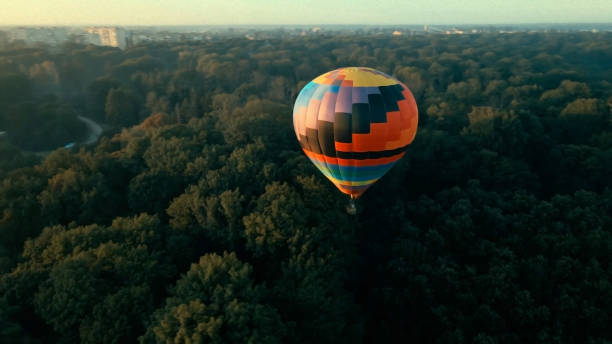 istock Hot air balloons over forest 1475463712