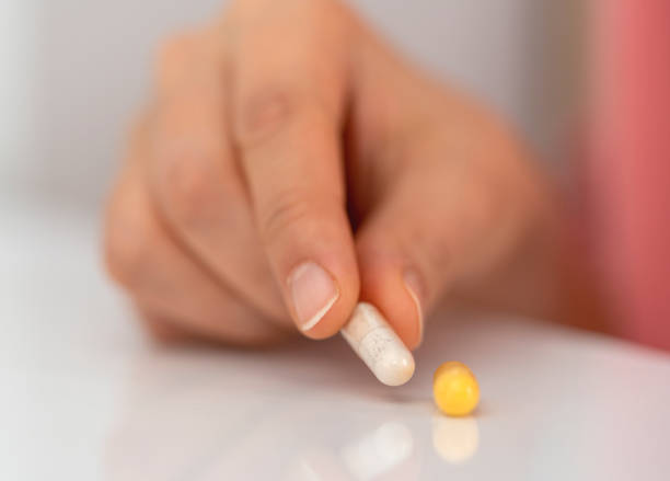 istock Woman hand holding a white pills 1475463876