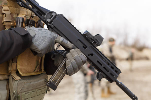 Ukrainian soldier training with modern 9mm submachine gun on military shooting range outdoor Soldier of Armed Forces of Ukraine practicing on shooting range outdoor with a modern Ukrainian 9mm sub machine gun militant groups stock pictures, royalty-free photos & images