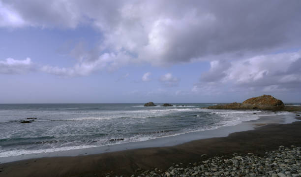 istock Scenic view of a beach against cloud sky 1475465520