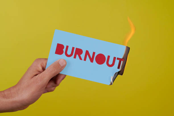 istock holding a sign on fire with the text burnout 1475466034