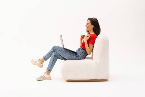 istock Beautiful woman working with a laptop, isolated over white background 1475466068