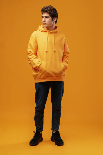 istock Full body image of young man posing on yellow background 1475468764