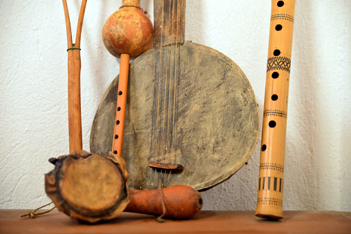 Antic handmade Music instrument: (left to right)\nEktara, Peruvian Shamanic Cacho Seed Rattle with Ribbon, Flute, Nay-i Narm, Didgeridoo