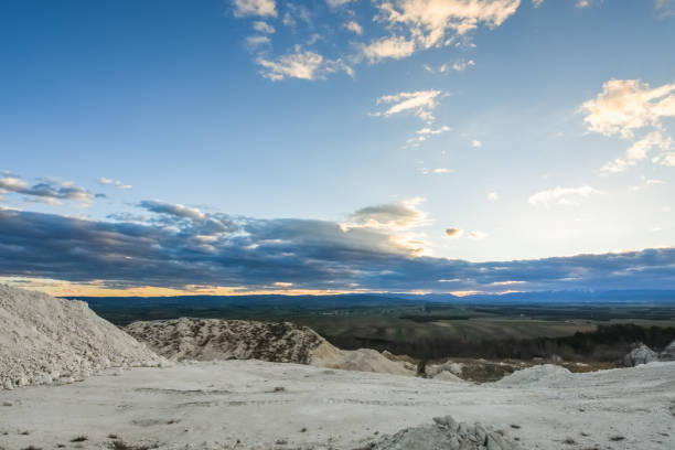 landscape with a lime quarry and colorful clouds during sundown in the spring