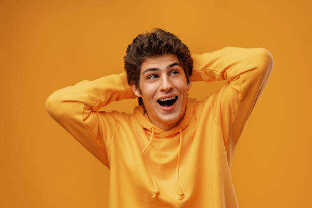 istock Young man over yellow background with surprised facial expression 1475470949