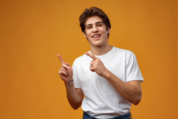 istock Young handsome man over blue background pointing to the side 1475470974