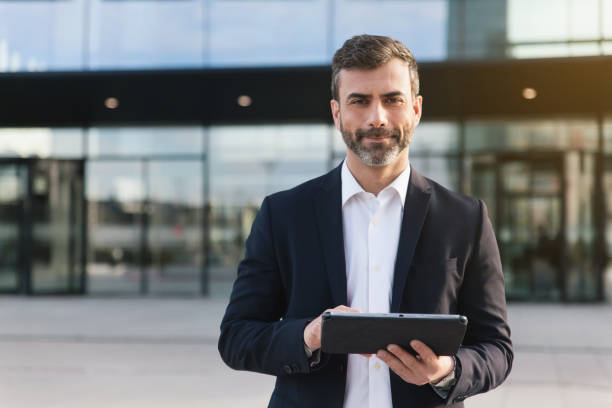 istock Businessman holding tablet in financial district 1475471836