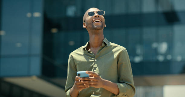 istock City, phone and black man walking while typing message, email or internet post with smile outside. Technology, 5g communication and urban networking, happy businessman online for gps location search. 1475472170