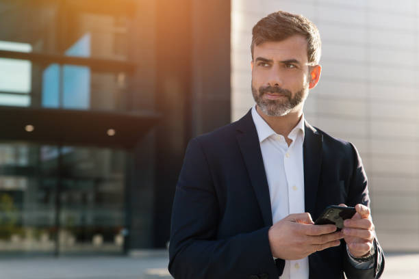 istock Businessman using smartphone in financial district 1475472739