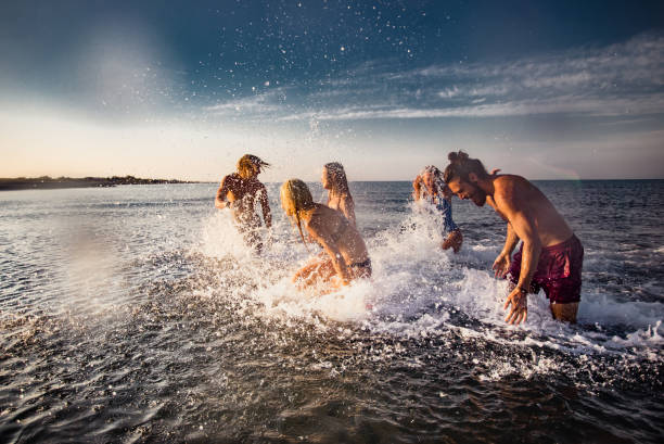 istock Group of happy people having fun while playing in the sea. 1475472839