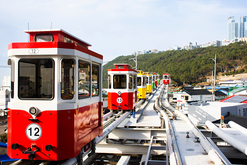 Korean people and foreign travelers sitting passengers journey on Sky Capsule Tram Haeundae Blue Line at Mipo Station for travel visit in Haeundae Beach Park at Haeundae gu city in Busan, South Korea