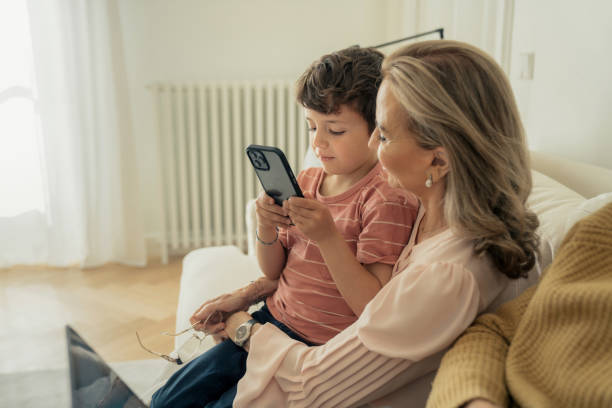 istock Grandmother and grandson using smartphone together 1475473683