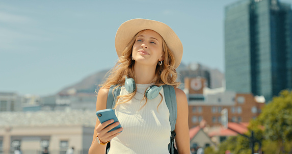 Travel, tourism and woman with phone in city, texting or social media on holiday or vacation. 5g cellphone, thinking and smile of happy female tourist with smartphone for networking or web browsing.