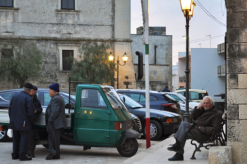 Group of Senior Men Talking in the Ancient Village Square in Salento, South Italy. Uggiano La Chiesa, Lecce Province