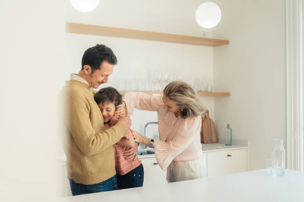 istock Boy hugging his father at home 1475476122