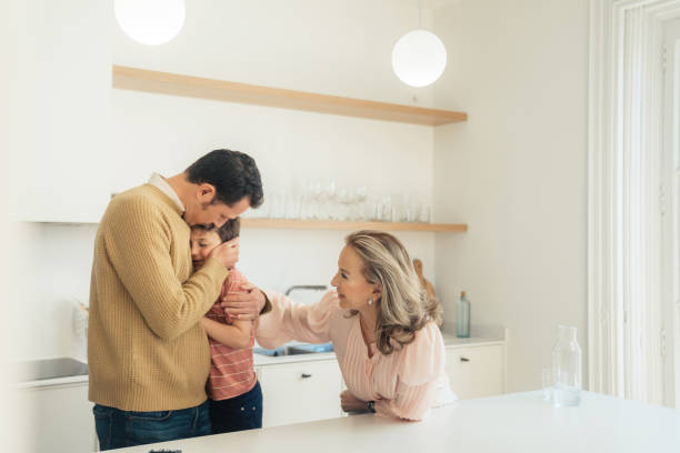 istock Boy hugging his father at home 1475476130