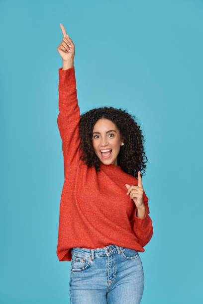 istock Young happy funky latin woman having fun dancing isolated on blue. 1475478703