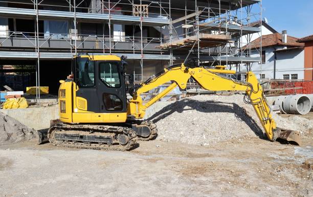 istock Excavator at work in front of residential building under construction. 1475479762