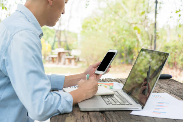 istock A man working with laptop remotely from home. A distant work place with many home plants. Person working from garden. 1475483728