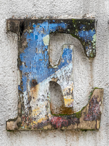 istock Dirty wooden alphabet letter on cement wall 1475484035
