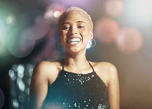 Portrait, happy woman and face with glitter and disco, party girl in night club with happiness and bokeh overlay. Celebration with dancing, smile and clubbing aesthetic with freedom, energy and fun