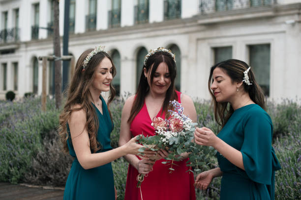 istock Three elegant women with a flower bouquet 1475488295