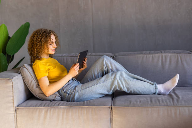 istock Young pretty woman using digital tablet at home 1475492058