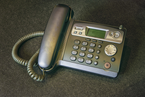 DECT radiotelephone Base station. Dect cordless phone wireless phone, radiotelephone, radio phone on grey background.