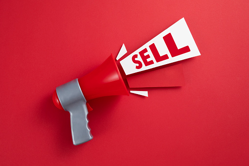 Sell message with red megaphone on red background