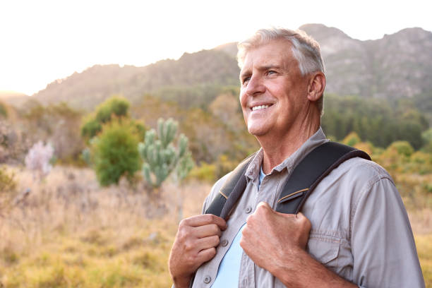 istock Portrait Of Active Senior Man With Backpack Going For Hike In Countryside 1475494091