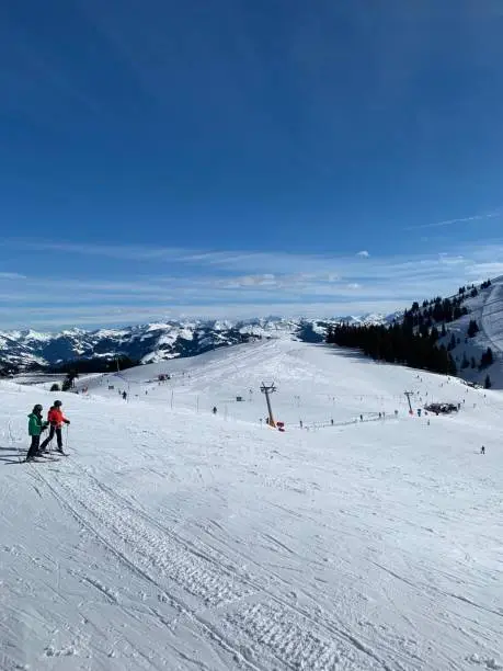 Austria skiing picture with lift and mountain range on the background.