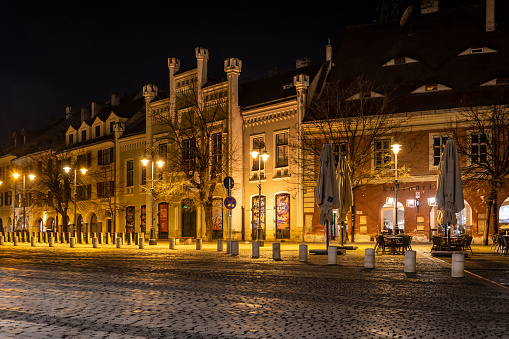 Sibiu, Romania. March 17, 2023: View across the ancient centre of Sibiu, Romania at night with shops and street cafes.
