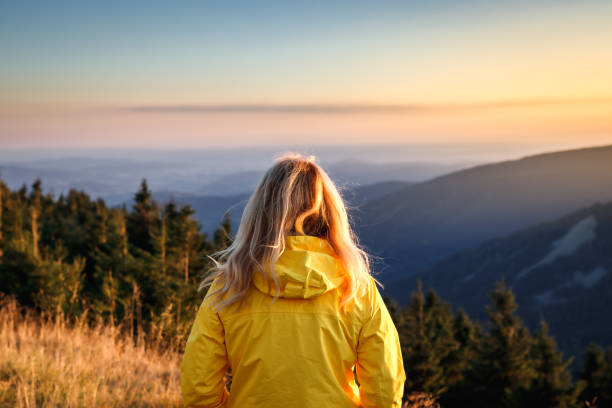 istock Female hiker enjoying sunset over mountains. 1475501139