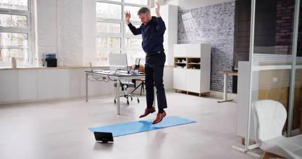 Burpee Training Exercise In Office. Man Jumping