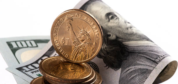 istock US$1 coins and US$100 banknote 1475501766