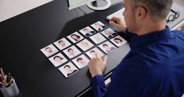 istock Selecting The Candidate Portrait Photo For Hiring 1475503345