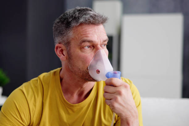 Asthma Patient Breathing Using Oxygen Mask stock photo