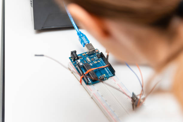 istock Female College Student Building Machine In Science Robotics Or Engineering Class.Stem education.Closeup. 1475505158