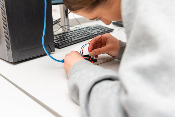 istock Female College Students Building Machine In Science Robotics Or Engineering Class.Stem education.Closeup. 1475505178