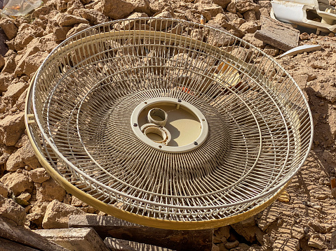 High angle view of plastic fan cover over rubble in garbage bin in the street